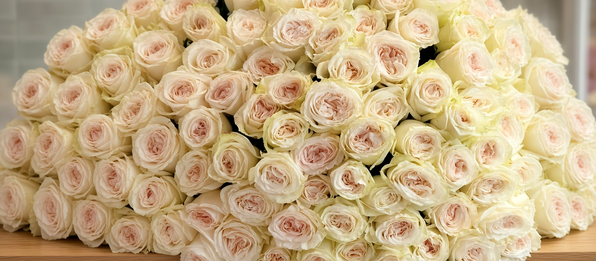Hand-tied white rose bouquet with a hot-pink ribbon